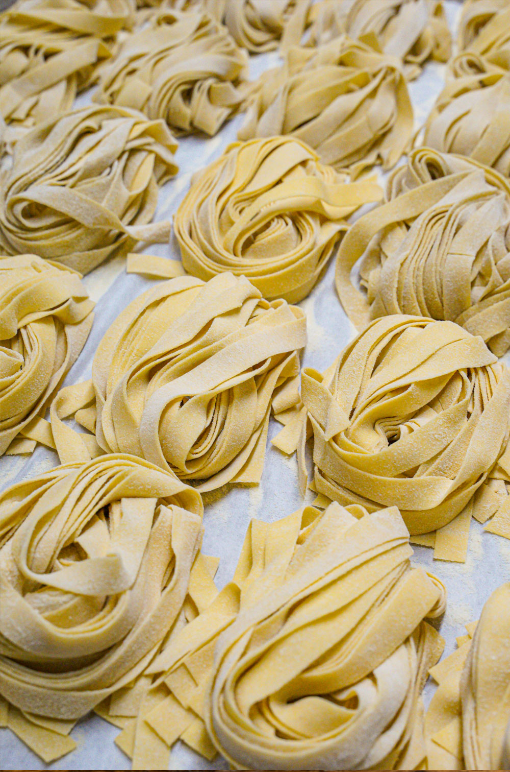 bunches freshly-made uncooked pasta on sheet pan at da laposta